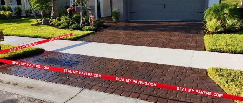 Paver driveway at 11697 Renaissance Drive with neatly straightened red Seal My Pavers barrier tape.
