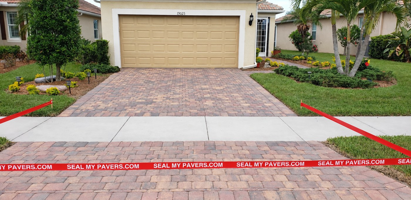 Dry, matte driveway pavers at Lappacio Street in IslandWalk, Venice, shown in the unfinished comparison.