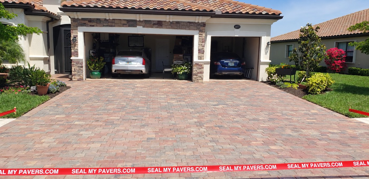 Dry, matte driveway pavers at Granlago Drive in Gran Paradiso, Venice, shown in the unfinished comparison.