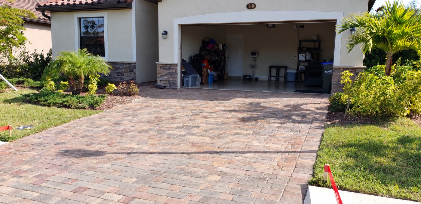 Dry, matte driveway pavers at Cinqueterre Drive in Gran Paradiso, Venice, shown in the unfinished comparison.