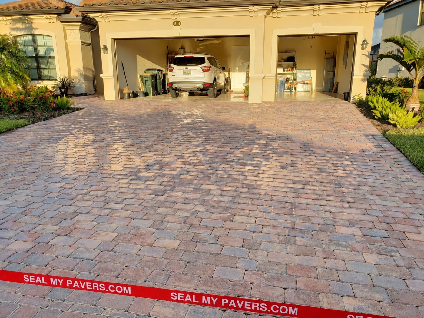 Dry, matte driveway pavers at 13165 Famiglia Drive in Gran Paradiso, Venice, shown in the unfinished comparison.