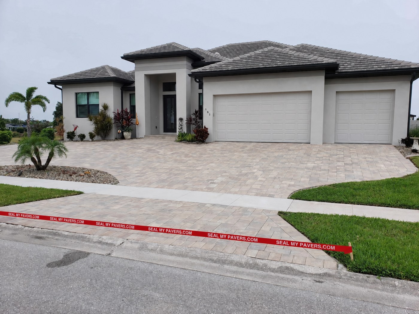 Dry, matte driveway pavers at Port Charlotte, Florida, shown in the unfinished comparison.