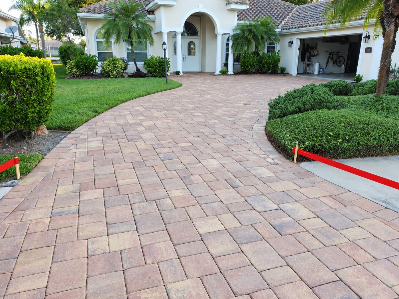 Dry, matte driveway pavers at Governors Green Drive in Plantation, Venice, shown in the unfinished comparison.